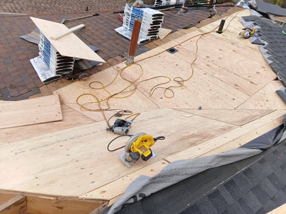 New plywood decking installed on a section of roof