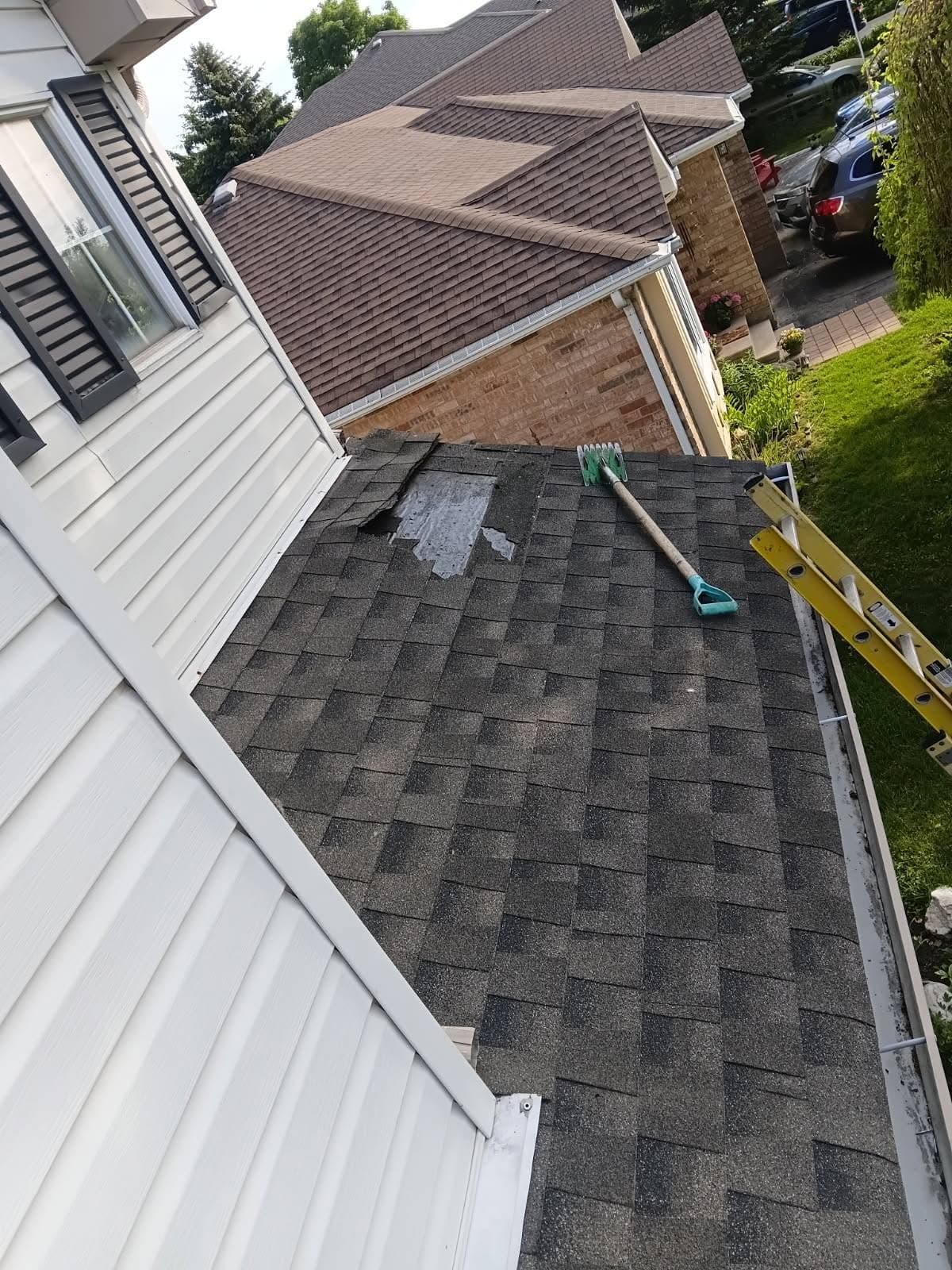 Completed shingle roof section between two siding walls
