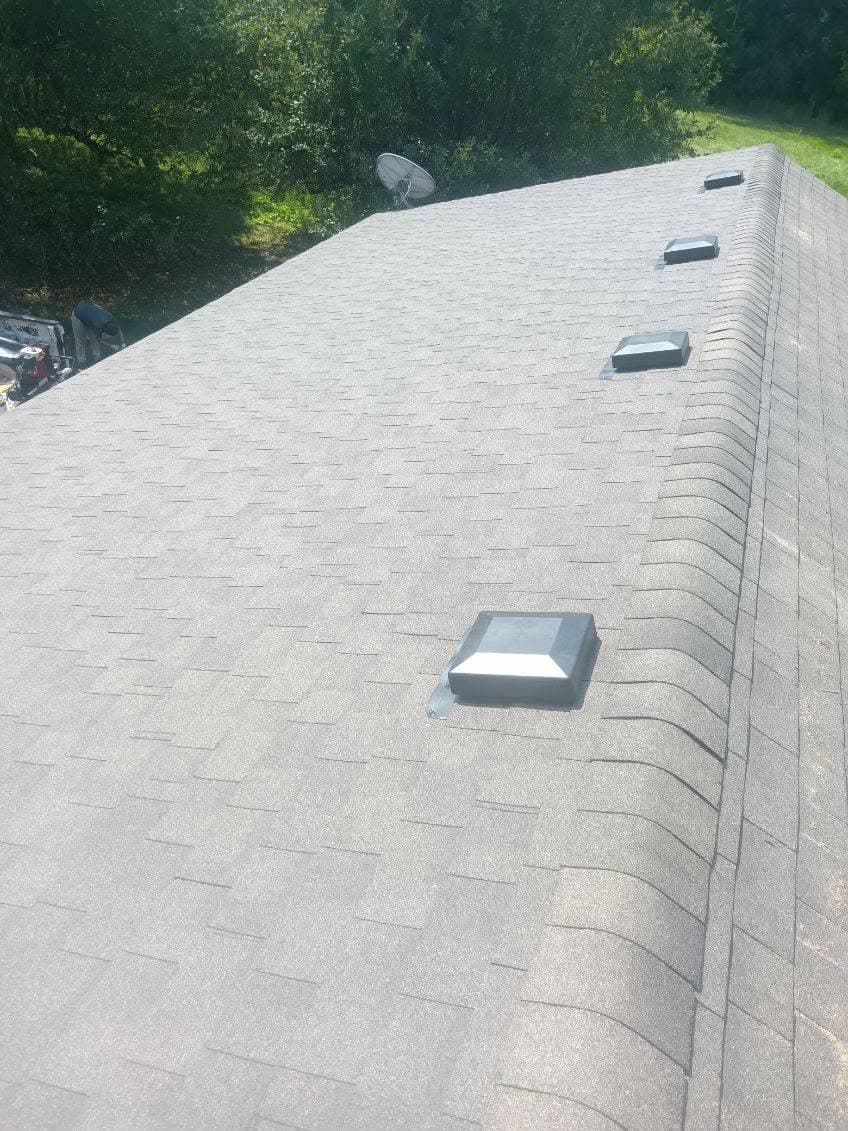 Finished roof with new shingles and roof vents running to the ridge