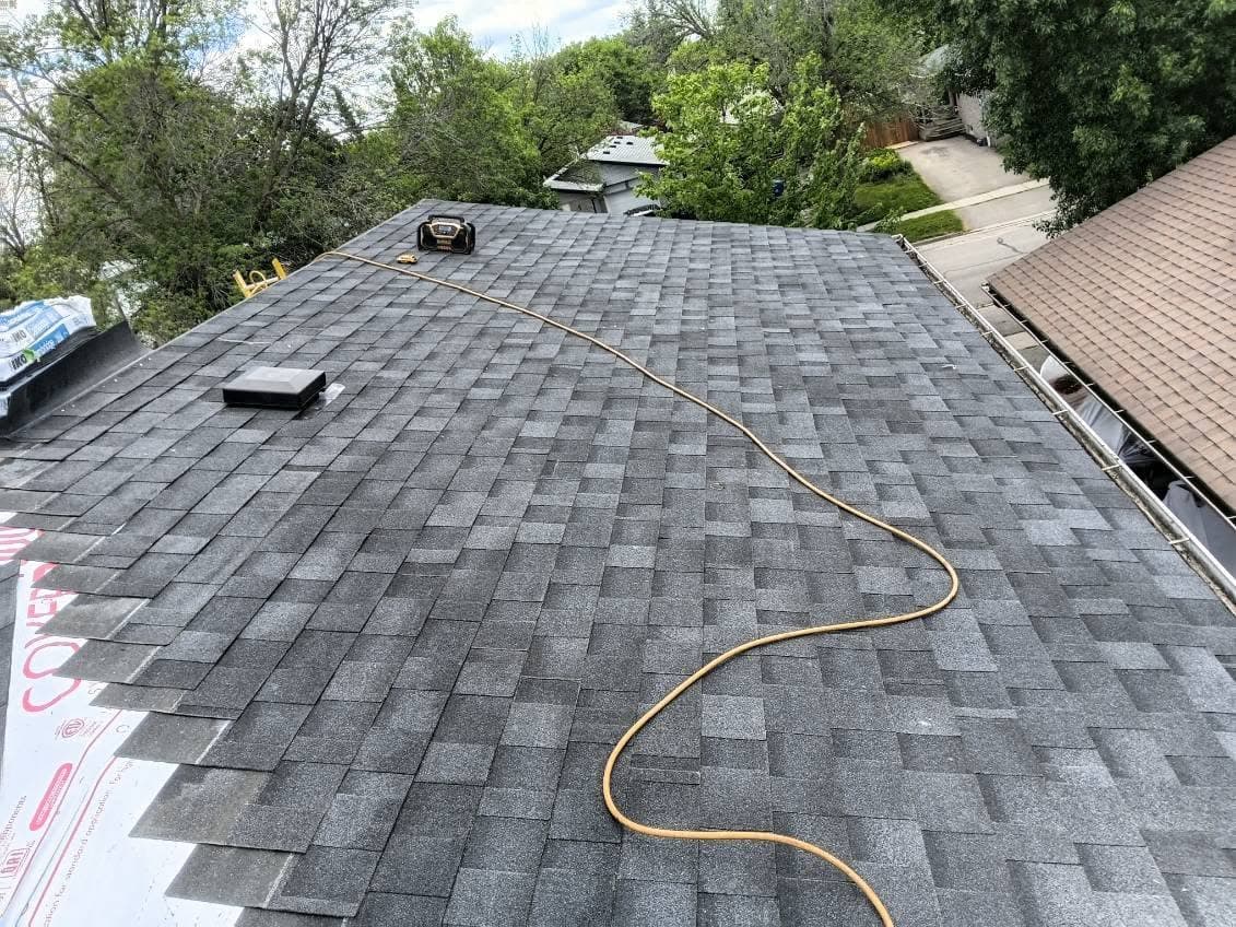 New charcoal architectural shingles installed across the roof