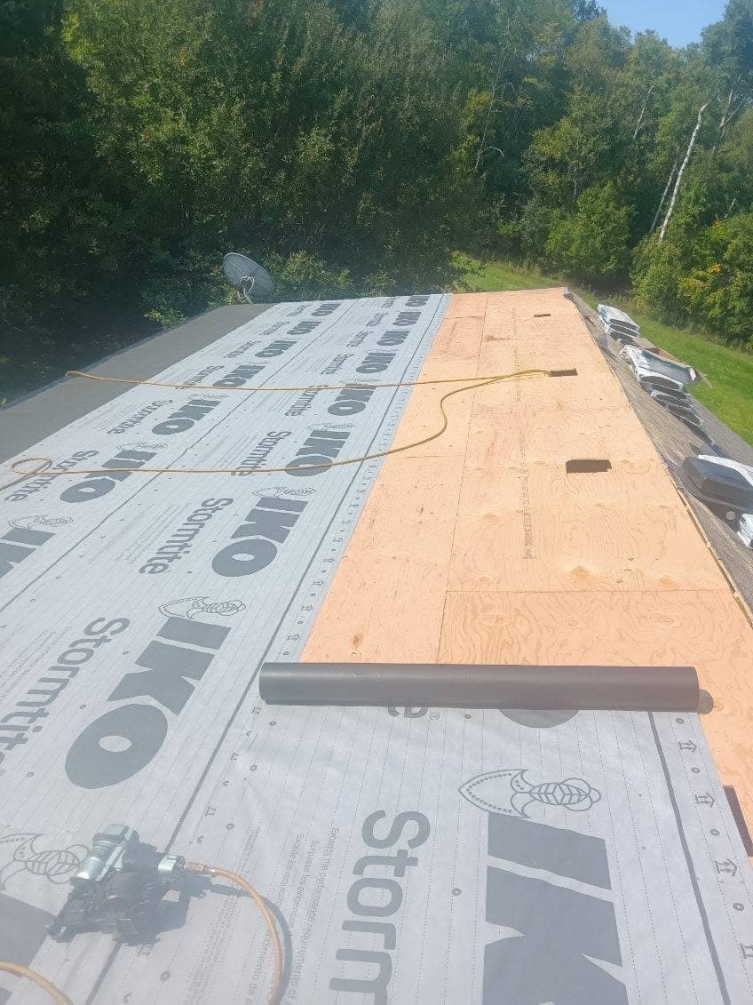 Roof decking covered in new underlayment on a residential street